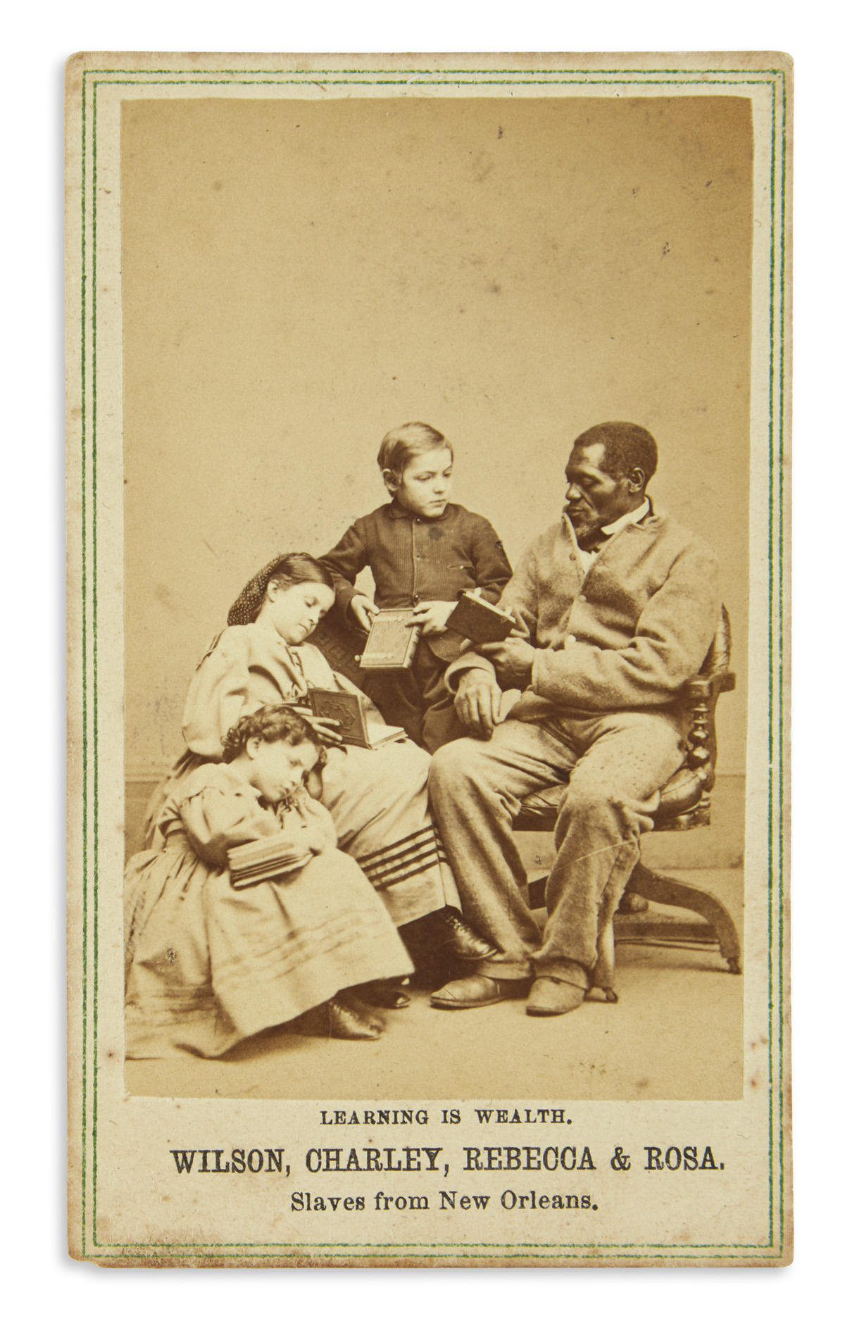 (SLAVERY AND ABOLITION.) Paxson, Charles; photographer. Learning is Wealth: Wilson, Charley, Rebecca & Rosa, Slaves from New Orleans.